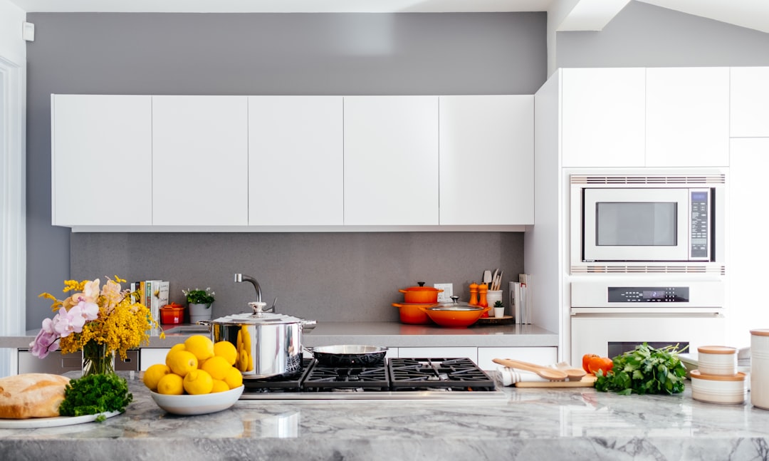 A well-organized kitchen with neatly arranged utensils, spices, and cooking tools, showcasing an efficient cooking space.